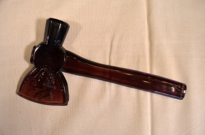 Amber glass hatchet from either the 1893 Chicago World’s Fair or the 1904 St. Louis World’s Fair. Made by the Libbey Glass Company at the World’s Fair Libbey Glass Demonstration Furnace where visitors could observe glass manufacture and then purchase the glass hatchets. They came in other colors such as opaque white, amethyst, green, and cobalt blue.